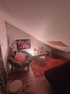 a living room with a chair and a table at Pension Relax in Litoměřice