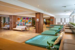a lobby with a row of beds in a room at INNSiDE by Meliá Ibiza Beach in San Antonio Bay +69 photos