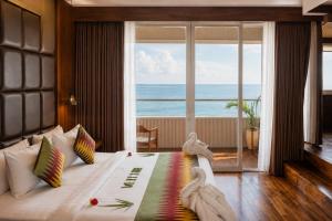 a bedroom with a bed with a view of the ocean at The Angkal Resort in Nusa Penida +142 photos
