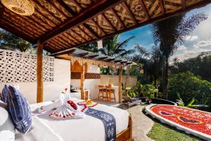 a bedroom in a villa with a bed at Uma Harum Sari by Dhananjaya Hospitality in Penginyahan +166 photos