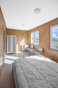 a bedroom with a large bed in a room at Cuma Camp in Sarbinowo