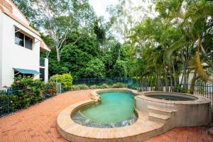 a small swimming pool in a brick walkway next to a house at Riverside Boulevard 13-151 close to HOSPITAL in Ross River