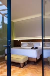 a bedroom with a bed and a glass door at Roso Guest House in Mexico City