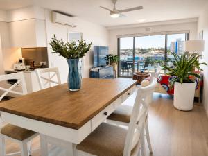 a kitchen and living room with a table and chairs at Harbourfront Views at Allure 2 Bedroom Apartment in Townsville