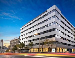 a tall white building with a street in front of it at Meliá Madrid Serrano in Madrid