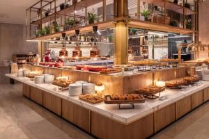 a buffet line with pastries and other food at Meliá Madrid Serrano in Madrid
