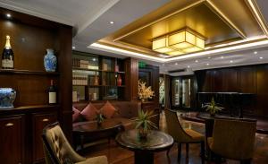 a room with a bar with a couch and a table at Paradise Elegance Cruise Halong in Ha Long
