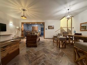 a living room with wooden furniture and a table at City Retreat Arusha in Arusha