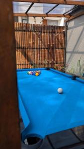 a blue pool table in a backyard at The Phalosaa Villa unit Cabana in Ngaglik