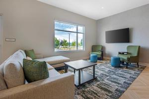 a living room with a couch and a tv at Cambria Hotel Bend - Mt Bachelor in Bend