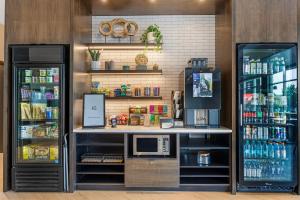 a coffee shop with a counter and a refrigerator at Cambria Hotel Bend - Mt Bachelor in Bend