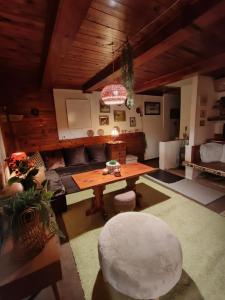 a living room with a table and a couch at Lesní chata Hvězdička in Litoměřice