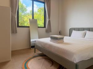 a bedroom with a bed and a large window at v15 Ocean Serenity Residence in Ko Phangan +25 photos