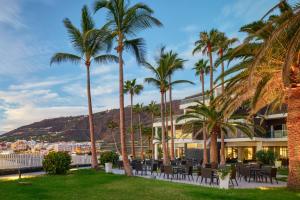 a hotel with palm trees and a view of the ocean at Meliá La Palma in Puerto Naos