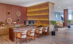 a lobby with a bar with stools at Meliá La Palma in Puerto Naos