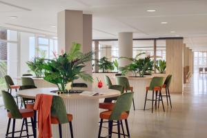 a cafeteria with a table and chairs and plants at Apartments La Palma, Affiliated by Meliá in Puerto Naos