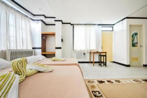 a large room with two beds and a table at Boracay Breeze Resort in Boracay +176 photos