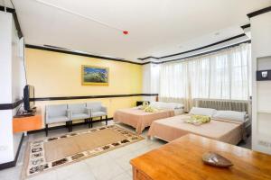 a living room with two beds and a couch at Boracay Breeze Resort in Boracay