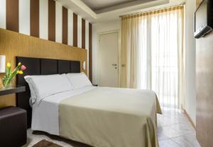 Posteľ alebo postele v izbe v ubytovaní ACasaMia WelcHome Hotel