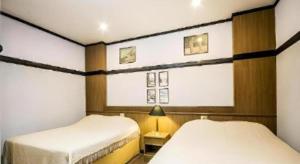 a room with two beds and a window in it at Numsin Hotel in Ban Rong Chang +169 photos