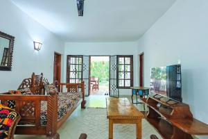 a living room with a couch and a table at Janari Stays in Kilifi