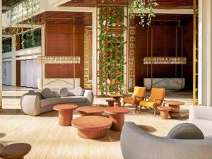a lobby with a couch and tables and chairs at Paradisus by Meliá Cancún -All Inclusive in Cancún