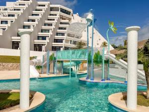 a water park in front of a building at Paradisus by Meliá Cancún -All Inclusive in Cancún