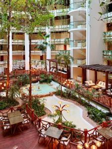 an outdoor patio with tables and chairs in a building at Paradisus by Meliá Cancún -All Inclusive in Cancún