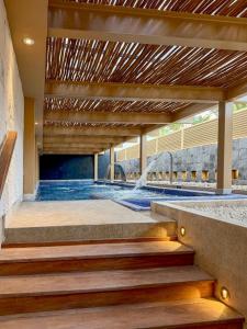 a swimming pool with stairs and a fountain at Paradisus by Meliá Cancún -All Inclusive in Cancún +106 photos