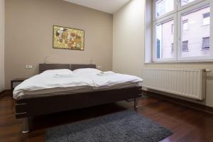 a bed in a room with a large window at Apartments Zagreb Point - Vinogradska in Zagreb
