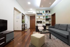 a living room with a couch and a tv at Apartments Zagreb Point - Vinogradska in Zagreb