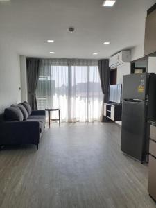 a large living room with a couch and a refrigerator at The High One in Ban Laem Thaen