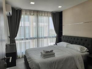 a bedroom with a bed with two towels on it at The High One in Ban Laem Thaen +112 photos