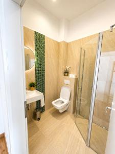 a bathroom with a toilet and a shower at LF Sports & Spa Hotel in Hannover