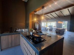 a kitchen with a counter with a stove in it at Annapurna Resort Puncak in Tagalbato