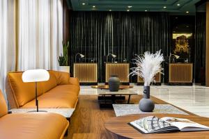 a living room with a couch and a table at Meliá Milano in Milan