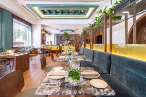 a long dining room with tables and chairs at Meliá Milano in Milan