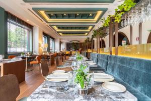 a long dining room with tables and chairs at Meliá Milano in Milan