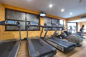 a gym with several exercise bikes in a room at Meliá Milano in Milan +82 photos