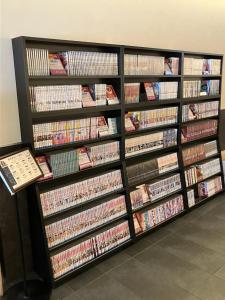 a book shelf filled with lots of dvds at KOKO HOTEL Osaka Namba Ebisucho in Osaka