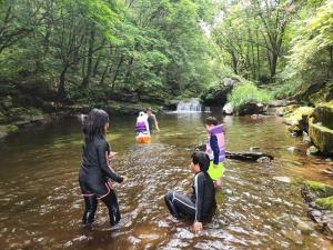 a group of people in the water in a river at Hwacheon Sankkun-uijib Pension in Hwach'ŏn