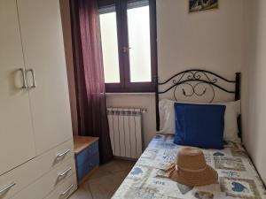 a bedroom with a bed with a blue pillow on it at Cavalluccio Marino-Central-with Balcony by Gessica Holiday in Polignano a Mare