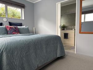 a bedroom with a bed and a walk in closet at Mason lane Apartment in Whangarei