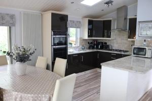a kitchen with a table with chairs and a counter top at High View Lodge in Windermere