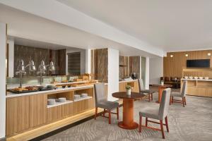 a kitchen with chairs and a table in a room at Sheraton Hanoi Hotel in Hanoi