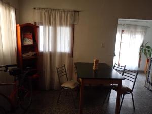 a dining room with a table and chairs and a window at Memento Vivere Boutique rooms in Neuquén