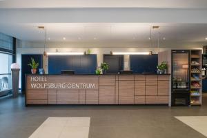 a hotel lobby with a hotel lobbying center at Hotel Wolfsburg Centrum, Affiliated by Meliá in Wolfsburg