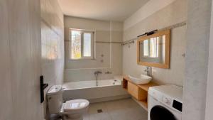 a bathroom with a tub and a toilet and a sink at Lióspito & Kochýli Constellation in Néa Koróni +15 photos