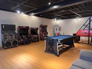 a room with a ping pong table and speakers at RECA Resort Philippines Luxury Villas & Nature Retreat in Porac