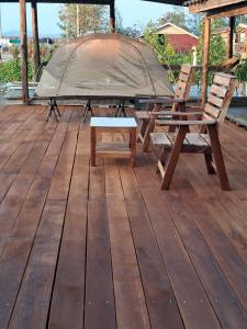 a picnic table and two chairs on a wooden deck at ชบาเฮาส์โฮมสเตย์ 